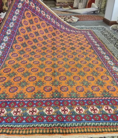 Golden Orange Hand-Knotted Afghan Bokhara, Size: 276 x 193 cm, Repeating Tekke Gul (medallion) pattern, High-quality wool on a durable cotton foundation.