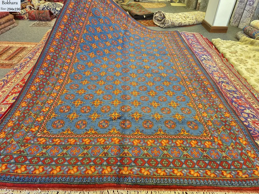 Hand-Knotted Afghan Bokhara, Size: 294 x 196 cm, in azure blue field with a traditional “gol” (elephant’s foot) pattern, High-quality wool on a durable cotton foundation.