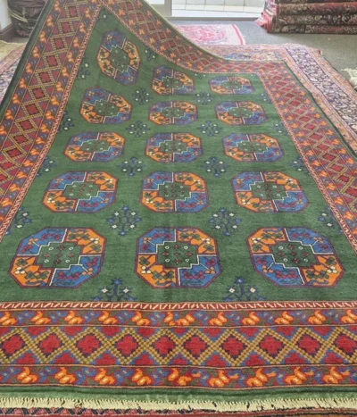 Hand-Knotted Afghan Bokhara rug, Size: 297 x 193cm, A rare and lush Emerald Green, Tekke Gül (Elephant Foot) octagonal motif, Crafted from premium wool with a lustrous finish.