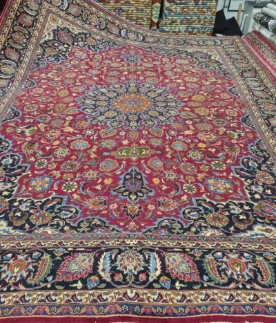 Authentic Hand-Knotted Mashad Rug, Size: 380 x 288 cm, high-quality, soft wool, Intricate Shah Abbasi floral motifs with a detailed central medallion, cochineal red field and midnight blue borders.