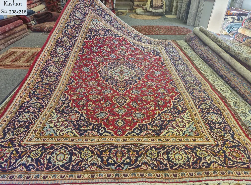 Hand-knotted Persian Kashan rug, Size: 298 x 216 cm, Traditional Central Medallion with intricate floral motifs, Crimson Red, Navy Blue, high-quality wool on a cotton foundation.