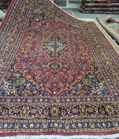 Handmade Kashan rug, Size: 294 x 195 cm, Traditional Central Medallion with intricate floral motifs, Crimson Red, Navy Blue, high-quality wool on a cotton foundation.