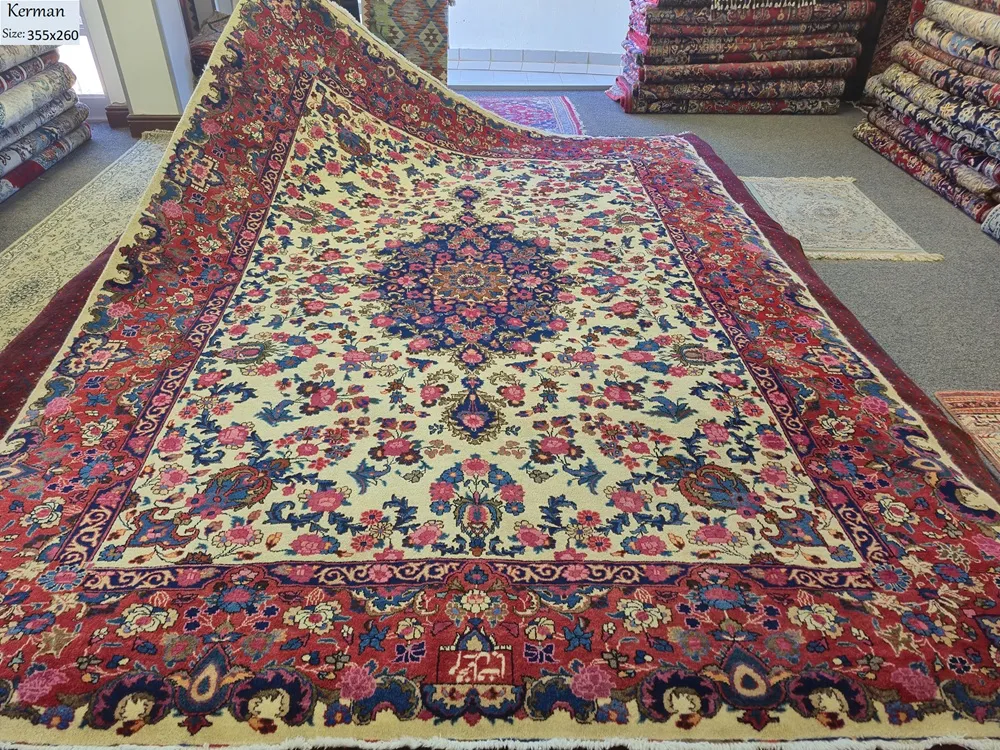 Pre loved hand-knotted Kerman, Size: 355 x 260 cm, sophisticated floral "Gol-e-Bolbol" (Rose and Nightingale) motif. Crafted with premium wool on a stable cotton foundation.