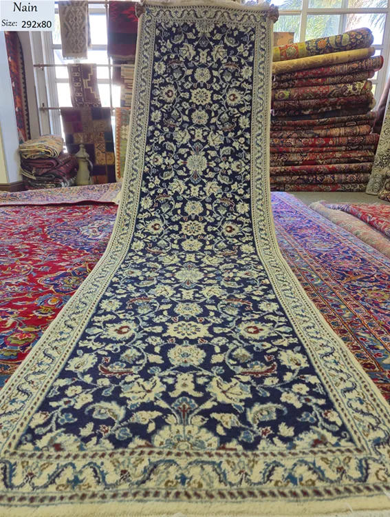 Pre-loved Hand-knotted Persian Nain runner, Size: 292 x 80 cm, deep navy field paired with the ivory floral motifs, hand-spun wool with fine silk.