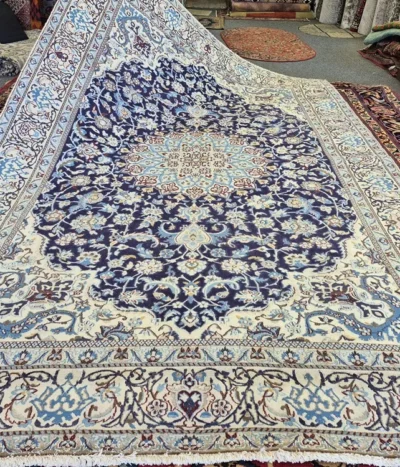 Persian handmade Nain rug, Size: 295 x 190 cm, second hand, central medallion and intricate floral motifs in a navy and ivory color. R 20 000 valuation certificate.