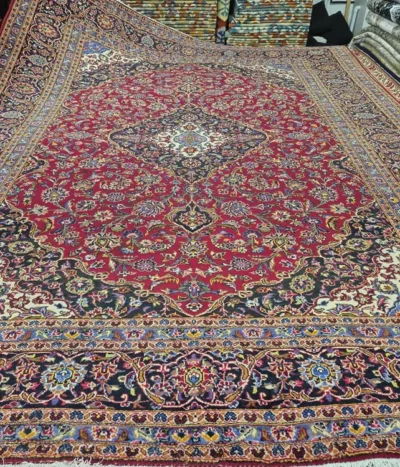 Pre loved Kashan Persian Rug, Size: 400 x 300 cm, Hand-Knotted by natural wool & vegetable dye, Deep red, navy blue, and ivory accents.