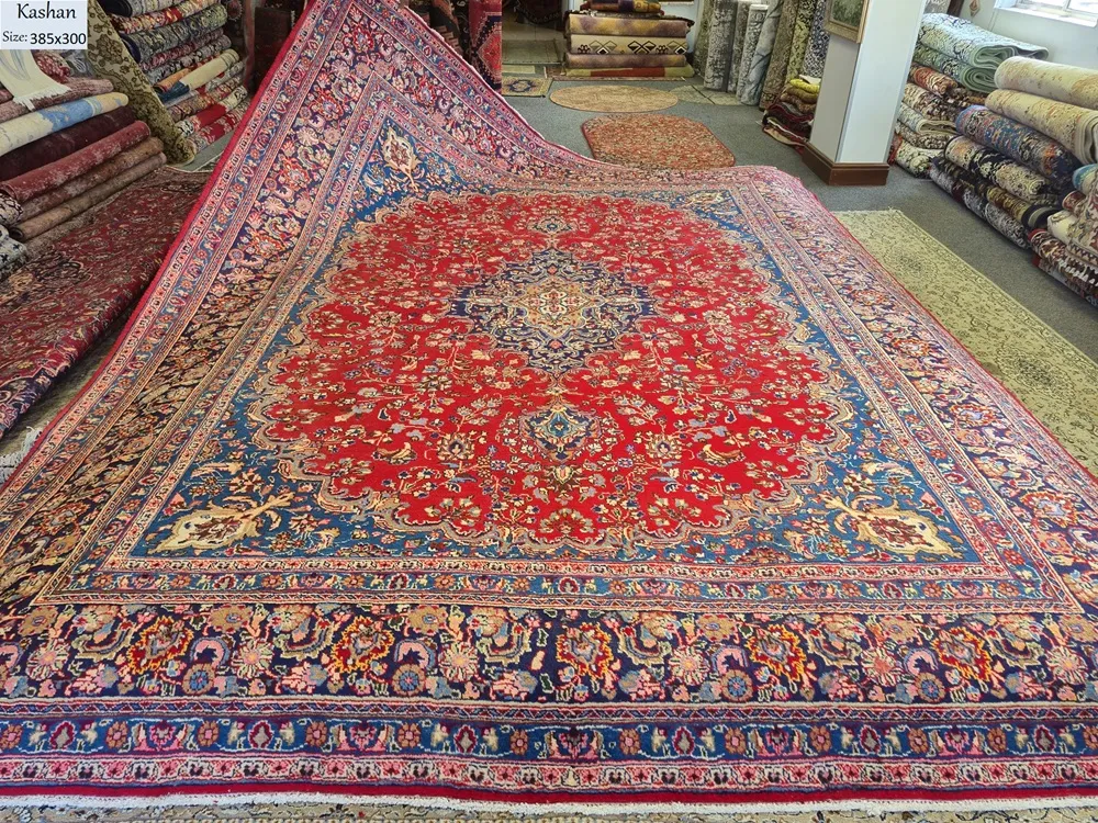 Premium Kashan Persian Rug is an authentic, hand-knotted masterpiece featuring a striking central medallion set against a vibrant crimson field. Size: 385 x 300 cm