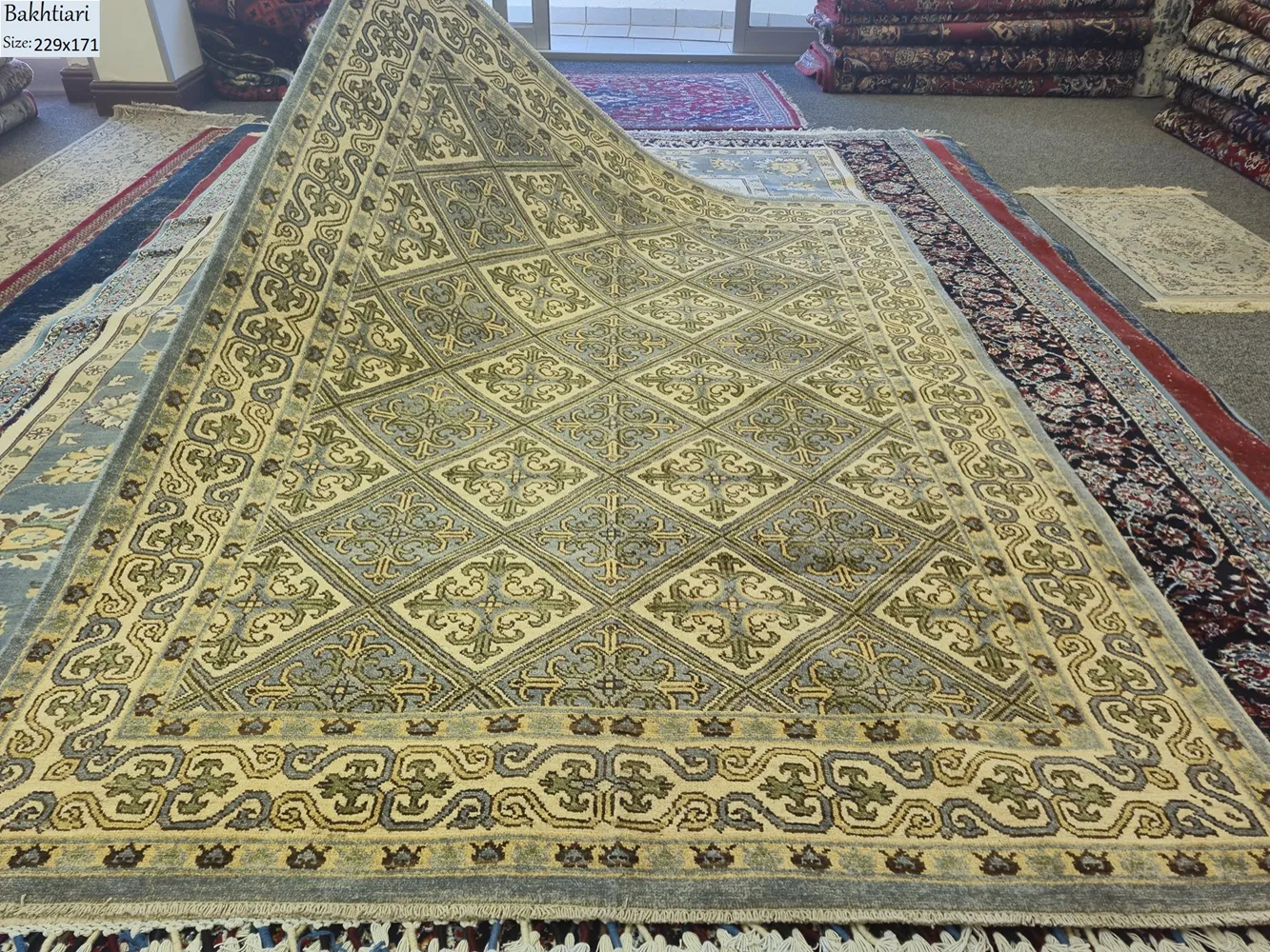 Bakhtiari Kheshti rug, Size: 229 x 171 cm, Fine hand-knotted diamond-shaped repeating geometric arabesque in muted sage greens, creams, and soft golds.