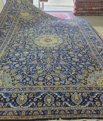 Exquisite  hand-knotted Nain Persian carpet, Size: 400 x 300 cm, features the timeless Shah Abbasi floral motif, Its design is centered around a radiant multi-lobed medallion, adorned with royal blue and gold accents. Crafted from fine Kork wool.