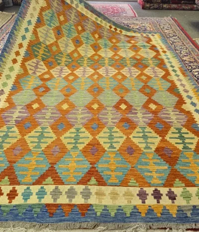 Authentic flat-weave Kilim, Size: 291 x 201 cm, Featuring a captivating repeat-diamond (lozenge) motif,  The vibrant interplay of terracotta, turquoise, and golden ochre makes it a versatile piece for both modern and traditional.
