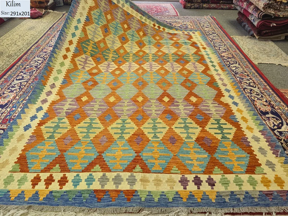 Authentic flat-weave Kilim, Size: 291 x 201 cm, Featuring a captivating repeat-diamond (lozenge) motif, The vibrant interplay of terracotta, turquoise, and golden ochre makes it a versatile piece for both modern and traditional.
