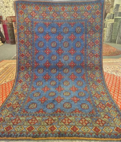 Traditional Hand-Knotted Afghan Bokhara, Size: 185 x 119 cm, iconic “gul” motif, cobalt blue-sage green, High-quality wool on a cotton foundation.