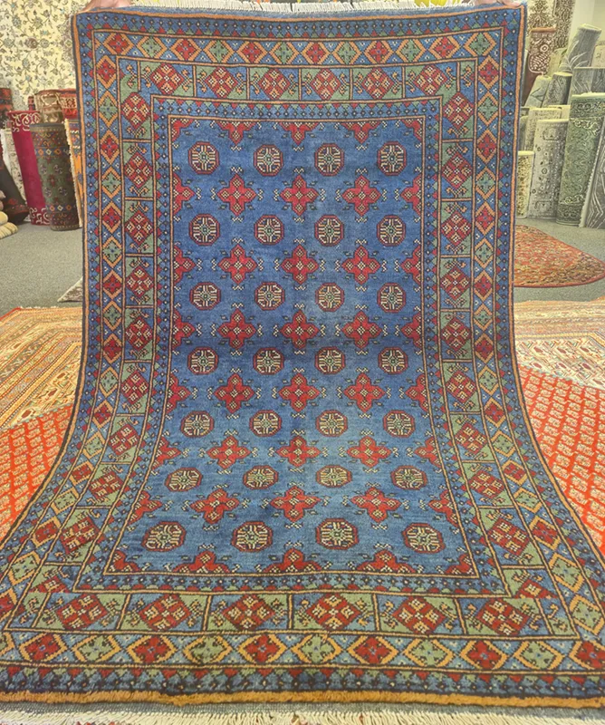 Traditional Hand-Knotted Afghan Bokhara, Size: 185 x 119 cm, iconic “gul” motif, cobalt blue-sage green, High-quality wool on a cotton foundation.