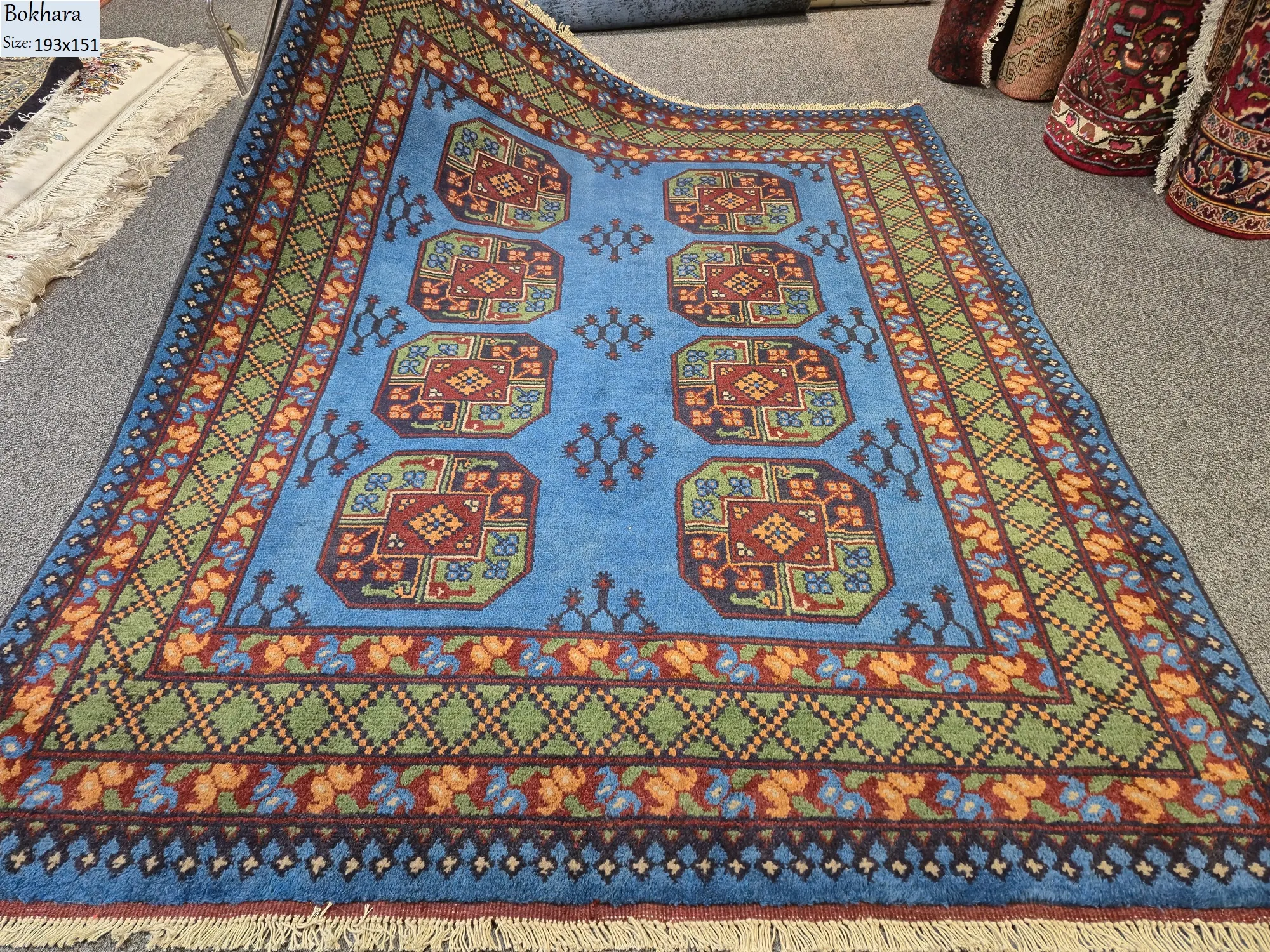 Hand-Knotted sky blue Bokhara rug, Size 193 x 151 cm,, repeating octagonal Guls (Elephant’s Foot) motifs, High-quality wool pile on a cotton foundation.