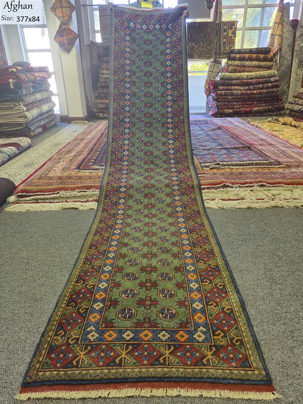 Hand-knotted Afghan Hallway runner, Size: 377 x 84 cm, sage-to-forest green field, featuring traditional tribal patterns, 100% Hand-Spun Wool on Cotton Warp.