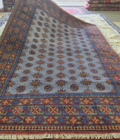 Hand-knotted Bokhara (Tribal Geometric), Size: 243 x 165 cm, steel-blue field combined with the multi-colored geometric borders, Dense plush wool pile with a soft handle, characteristic of high-quality hand-knotted pieces.