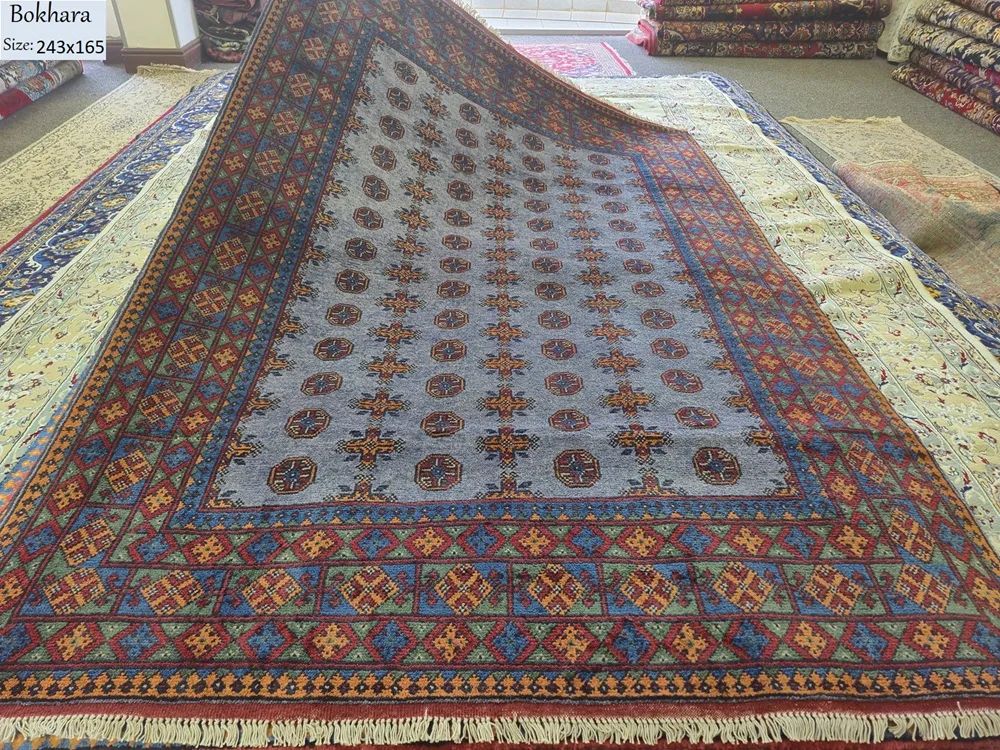 Hand-knotted Bokhara (Tribal Geometric), Size: 243 x 165 cm, steel-blue field combined with the multi-colored geometric borders, Dense plush wool pile with a soft handle, characteristic of high-quality hand-knotted pieces.