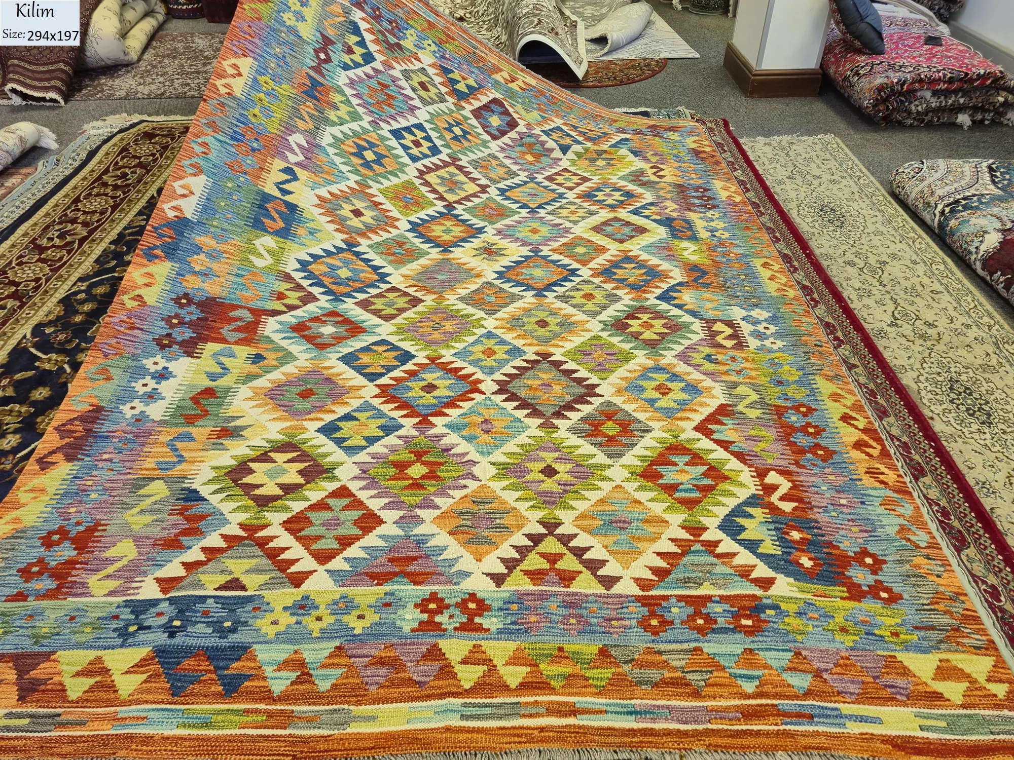 Handwoven Kilim rug, Size: 294 x 197 cm, Traditional geometric diamond motifs. Rich tapestry of turquoise, sunset orange, deep crimson & earthy mustard tones.