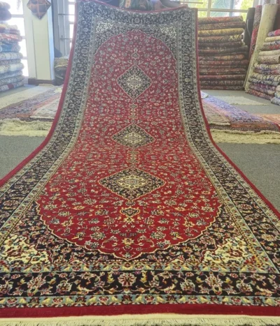 Kashan Hallway runner, Size: 395 x 145 cm, Triple Medallion layout set against a rich crimson field. Shah Abbasi floral motifs and elegant scrolling vine-work. 350 knots wool on cotton quality.