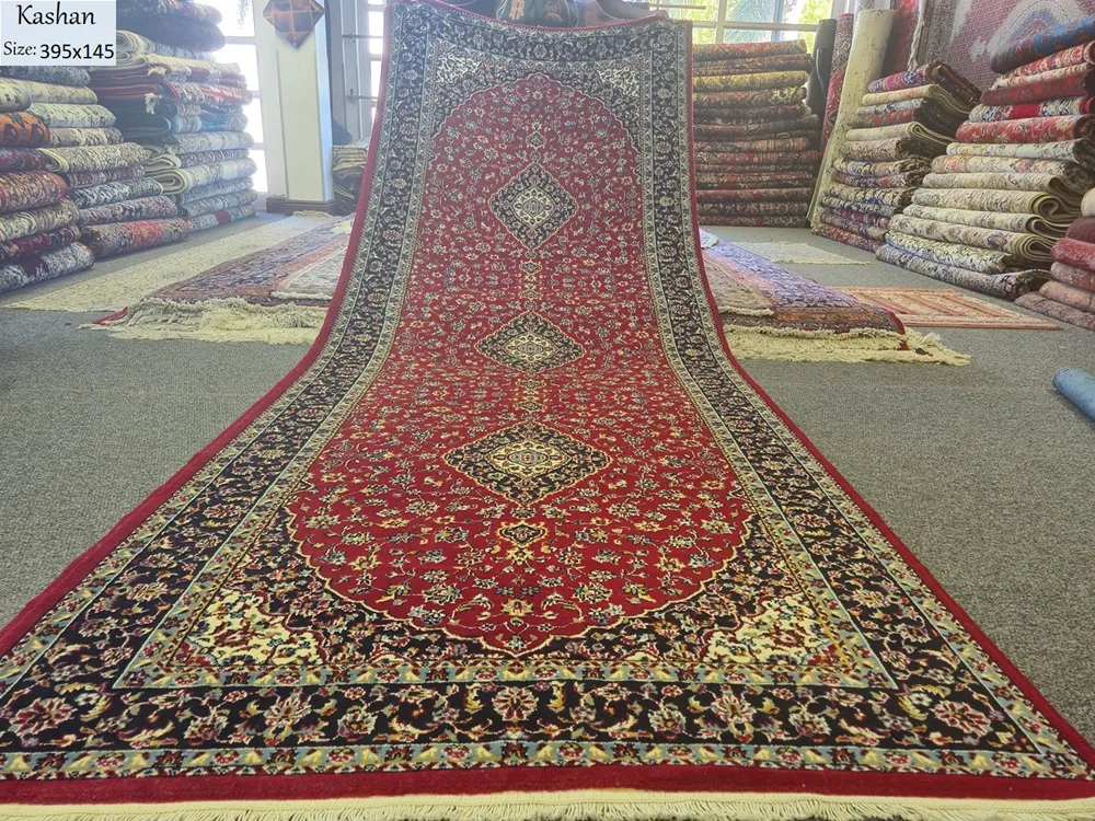 Kashan Hallway runner, Size: 395 x 145 cm, Triple Medallion layout set against a rich crimson field. Shah Abbasi floral motifs and elegant scrolling vine-work. 350 knots wool on cotton quality.