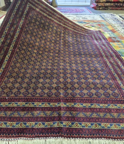 Premium Bokhara rug, Size: 200 x 145 cm, Fine hand-knotted by kurk wool & vegetable dye, Repeating Tekke Gul in a deep burgundy & navy blue foundation is highlighted by vibrant gold & green accents within the geometric borders pattern.