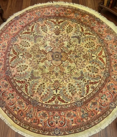 Hand-Knotted round silk Isfahan rug, Size: 254 x 251 cm, Floral central medallion surrounded by an "Islimi" arabesque pattern, Terracotta Red, Deep Blue, and Soft Gold, Premium silk on Kork wool.