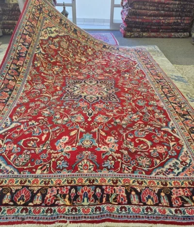 Antique Hand-knotted Mashad rug, Size: 330 x 220 cm, Rich floral medallion pattern with a deep red field and navy borders, High-quality wool on cotton foundation.