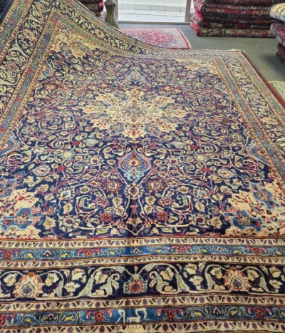Authentic Hand-knotted Persian Isfahan, Size: 377 x 288 cm, navy blue field with golden central medallion surrounded by an intricate dance of scrolling floral vines and classic paisley motifs, Artist's signature woven in.