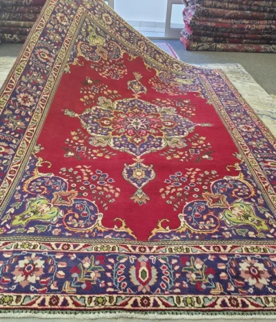 Authentic hand-knotted Tabriz carpet, Size: 290 x 195 cm, intricate 16-pointed central starburst medallion set against a radiant cherry-crimson field, multi-layered, deep indigo main border, Fine-quality wool on cotton foundation.
