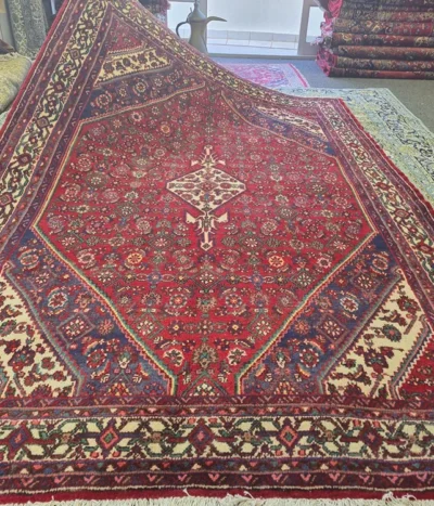 Fine Handmade Hamedan rug, Size: 310 x 205 cm, geometric diamond medallion, crimson red, indigo blue, 100% premium wool pile on a cotton foundation.