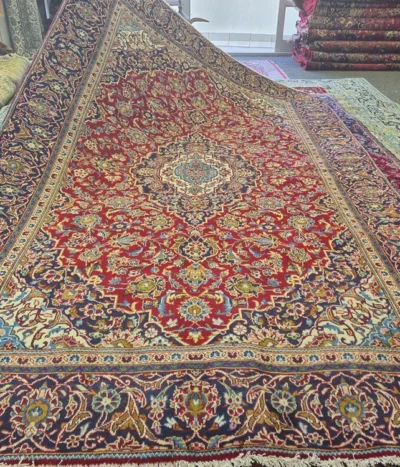 Genuine Hand-Knotted Kashan, Size: 285 x 190 cm, meticulous floral motifs (Shah Abbasi patterns) in crimson red, navy & gold knotted by premium wool on a durable cotton foundation.