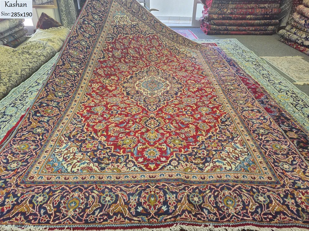 Genuine Hand-Knotted Kashan, Size: 285 x 190 cm, meticulous floral motifs (Shah Abbasi patterns) in crimson red, navy & gold knotted by premium wool on a durable cotton foundation.