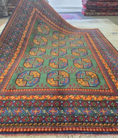 Hand-Knotted Afghan Bokhara rug, Size: 240 x 168 cm, A rare and lush Emerald Green, Tekke Gül (Elephant Foot) octagonal motif, Crafted from premium wool with a lustrous finish.