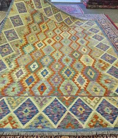 Hand-Woven Afghan Flatweave, Size: 297 x 212 cm, features a classic stepped diamond lattice design, terracotta, turquoise, sage green, and lavender, framed by a deep indigo-toned geometric border, 100% Hand-spun Wool on a Wool foundation.