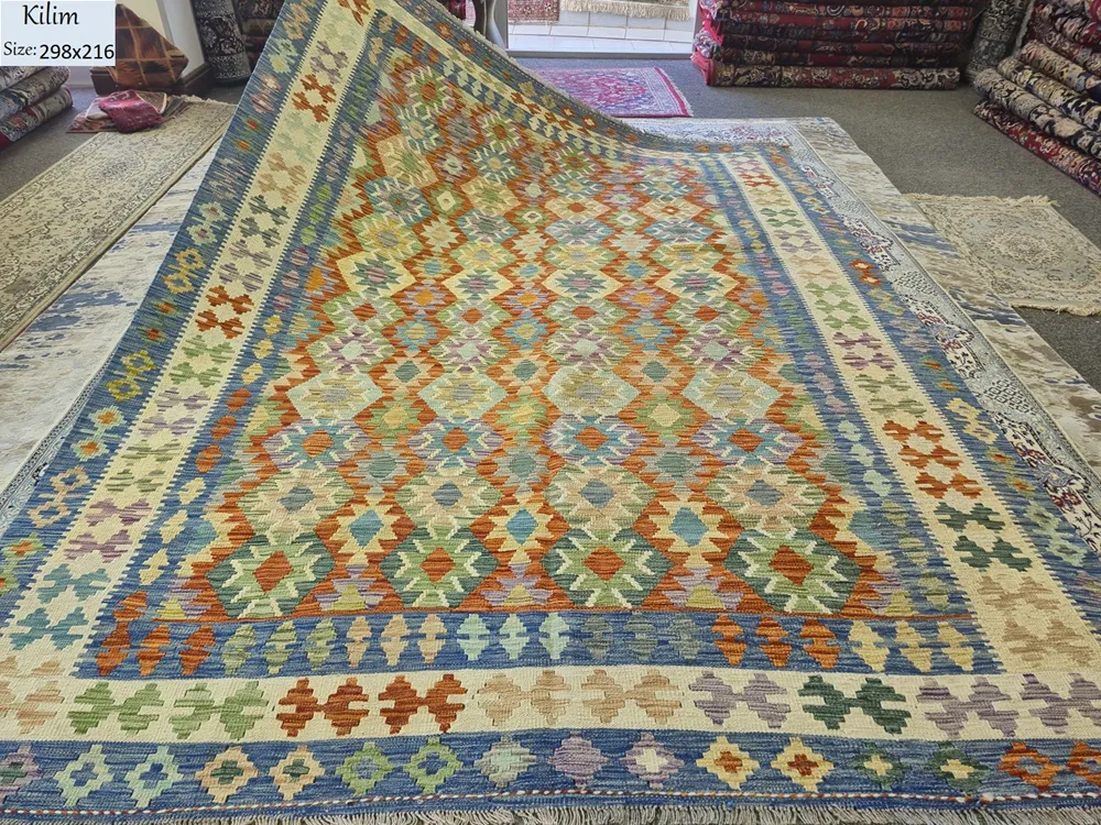 Hand-Woven Afghan Kilim, Size: 298 x 216 cm, Traditional geometric diamond medallions, vibrant harmony of terracottas, warm oranges, soft greens, muted purples, and striking lapis blue accents on a classic cream ground, 100% Hand-spun Wool on a Wool foundation.