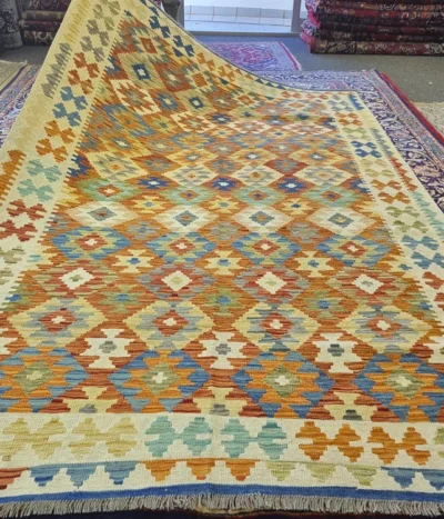 Flat Hand-Woven Kilim, Size: 303 x 203 cm, geometric artistry of traditional Afghan, terracotta, mustard yellow, and deep azure blue—is accented by ivory.