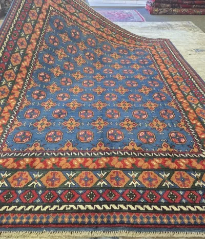 Handmade Afghan Bokhara, Size: 245 x 165 cm, in azure blue field with a traditional “gol” (elephant’s foot) pattern, High-quality wool on a durable cotton foundation.