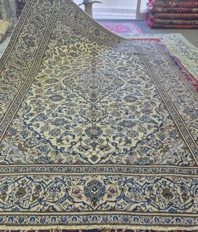 Second Hand Kashan rug, Hand-knotted cream field, diamond-shaped medallion (Toranj) surrounded by detailed arabesques & floral motifs that radiate outwards, wool on cotton foundation.