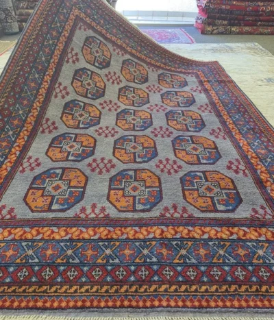 Handmade Bokhara ((Elephant’s Foot) motifs, Size: 244 x 165 cm, steel-blue field combined with the multi-colored geometric borders, Dense plush wool pile with a soft handle, characteristic of high-quality hand-knotted pieces.