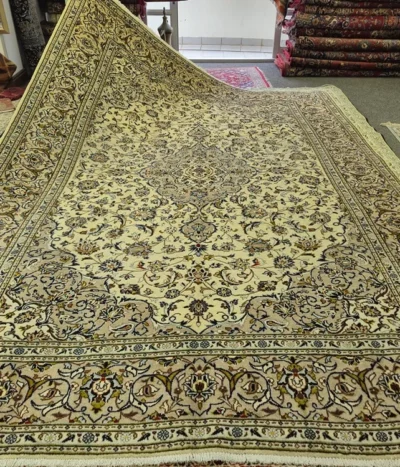 Vintage Kashan Persian Carpet, Size: 357 x 248 cm, cream field, diamond-shaped medallion (Toranj) surrounded by detailed arabesques & floral motifs that radiate outwards, wool on cotton foundation.