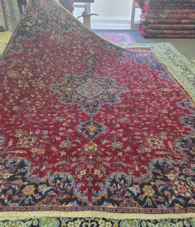 Hand-knotted Vintage Mashad rug, Size: 285 x 205 cm, Classic Shah Abbasi medallion with intricate floral motifs in deep burgundy hue, The slight natural variations in shading known as abrash, hand-spun wool on cotton foundation.
