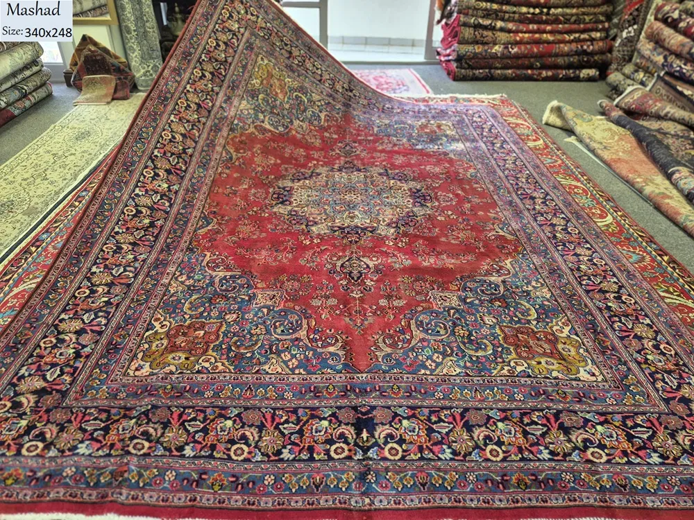 Vintage Hand-Knotted Mashad rug, Size: 340 x 248 cm, classic central medallion surrounded by intricate floral motifs, wool on cotton foundation.