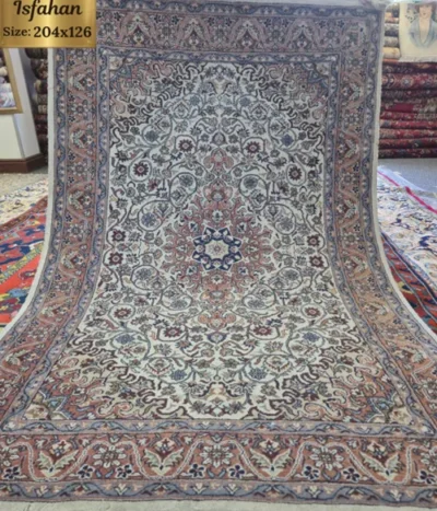 Pre-loved Authentic Handcrafted Persian Isfahan Carpet, Size: 204 × 126 cm, Features a commanding eight-pointed star central medallion enveloped by tight floral motifs and swirling arabesques on a rich cream field, Premium Wool Pile on Durable Cotton Foundation.