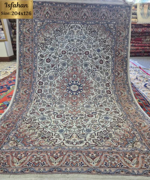 Pre-loved Authentic Handcrafted Persian Isfahan Carpet, Size: 204 × 126 cm, Features a commanding eight-pointed star central medallion enveloped by tight floral motifs and swirling arabesques on a rich cream field, Premium Wool Pile on Durable Cotton Foundation.