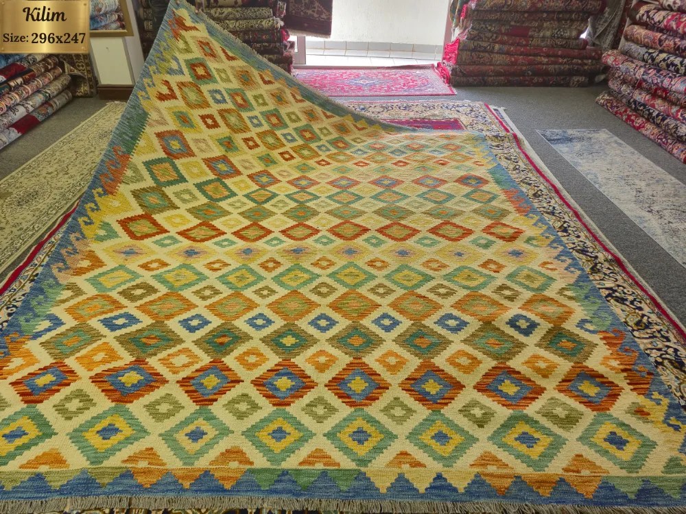 Hand-Woven Afghan Kilim, Size: 296 x 247 cm, Traditional geometric diamond medallions, vibrant harmony of sun-warmed gold, sage green, terracottas, and vibrant blues, 100% Hand-spun Wool on a Wool foundation.