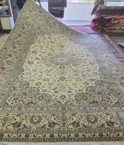 Hand-Knotted Persian Nain carpet, Size: 387 x 245 cm. refined ivory and cream foundation adorned with intricate floral motifs and delicate blue, gold, and burgundy accents, wool pile on cotton foundation.