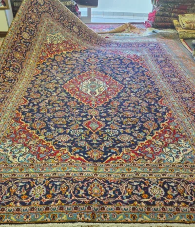 Pre-loved Hand-Knotted Persian Kashan Rug, Size: 348 x 265 cm, deep navy, crimson, ivory, teal and touches of gold, wool on a cotton foundation.